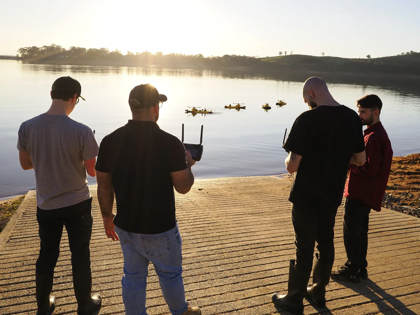 A field team observing a Surfbee vessel on the water